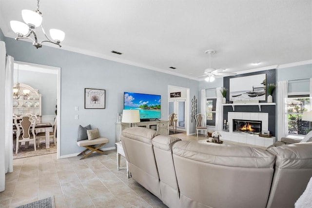 109 Lake Mariam Way, Winter Haven, FL 33884 - living room featuring a chandelier, crown molding, a tile fireplace, ceiling fan, and light tile patterned floors