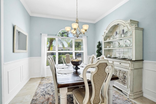 109 Lake Mariam Way, Winter Haven, FL 33884 - dining space featuring a chandelier, wainscoting, ornamental molding, and a decorative wall