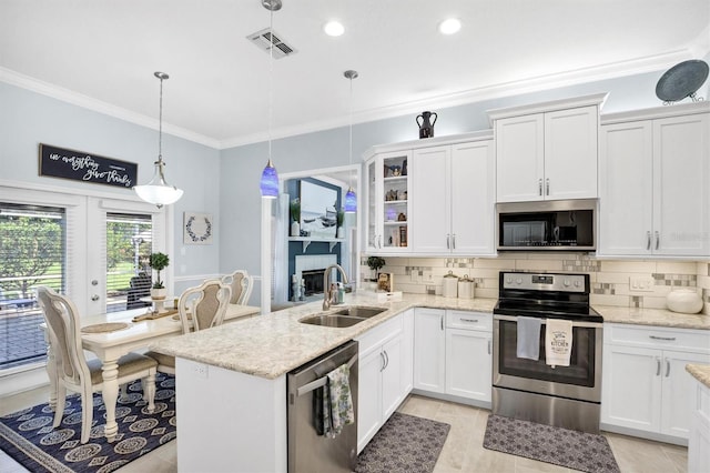 109 Lake Mariam Way, Winter Haven, FL 33884 - kitchen with stainless steel appliances, a sink, ornamental molding, decorative backsplash, and white cabinets