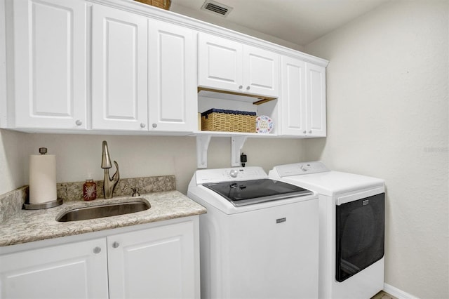 109 Lake Mariam Way, Winter Haven, FL 33884 - laundry area with cabinet space and washing machine and dryer