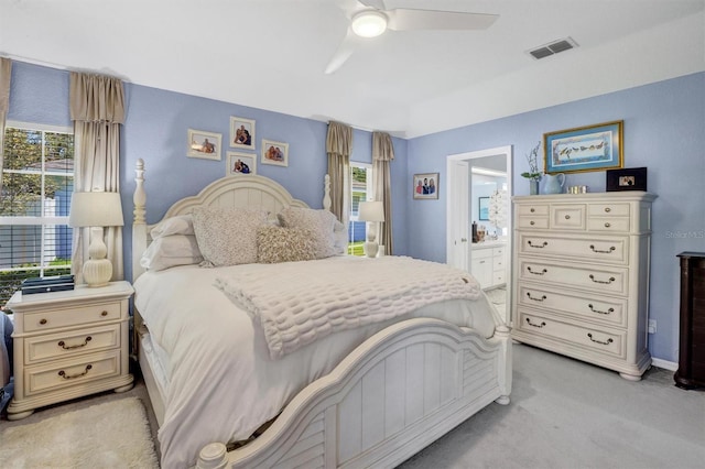 109 Lake Mariam Way, Winter Haven, FL 33884 - bedroom featuring light colored carpet, ensuite bathroom, and ceiling fan
