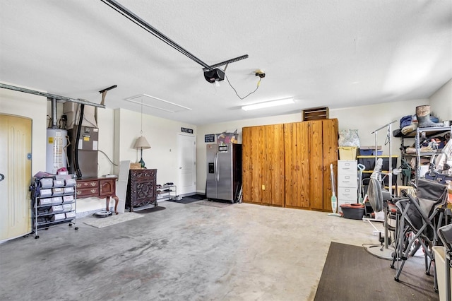 109 Lake Mariam Way, Winter Haven, FL 33884 - garage featuring stainless steel refrigerator with ice dispenser, water heater, a garage door opener, and heating unit