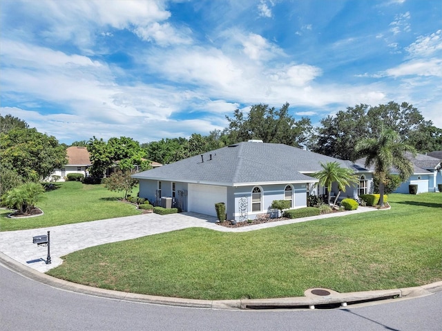 109 Lake Mariam Way, Winter Haven, FL 33884 - ranch-style home featuring a front yard, decorative driveway, an attached garage, roof with shingles, and cooling unit