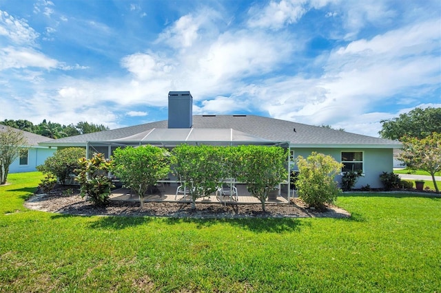 109 Lake Mariam Way, Winter Haven, FL 33884 - rear view of house featuring a patio, a lawn, a chimney, and glass enclosure