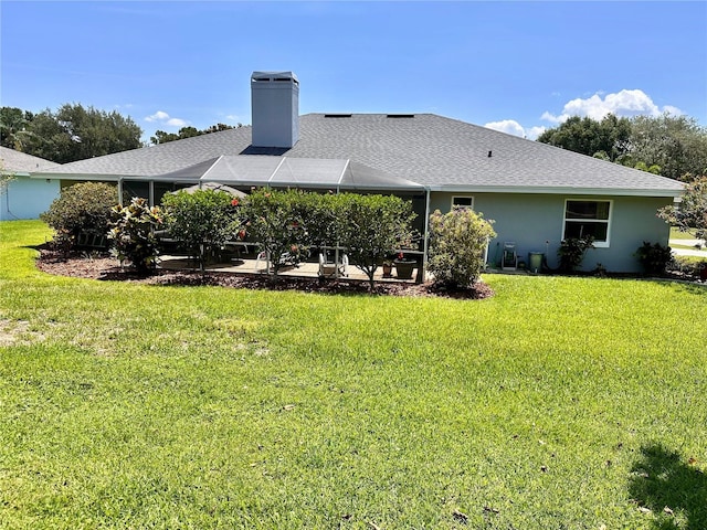 109 Lake Mariam Way, Winter Haven, FL 33884 - back of house with a patio area, a lawn, a chimney, and a shingled roof