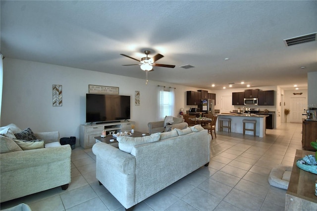 4400 Trotters Way, Lakeland, FL 33801 - living area featuring light tile patterned floors and a ceiling fan