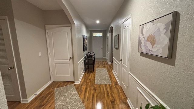 3828 Eloise Estates Ct, Winter Haven, FL 33881 - hallway featuring arched walkways, a textured wall, dark wood finished floors, recessed lighting, and baseboards