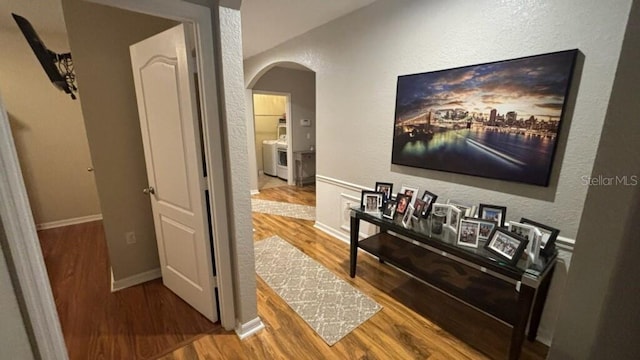 3828 Eloise Estates Ct, Winter Haven, FL 33881 - hall featuring arched walkways, wood finished floors, a textured wall, and baseboards