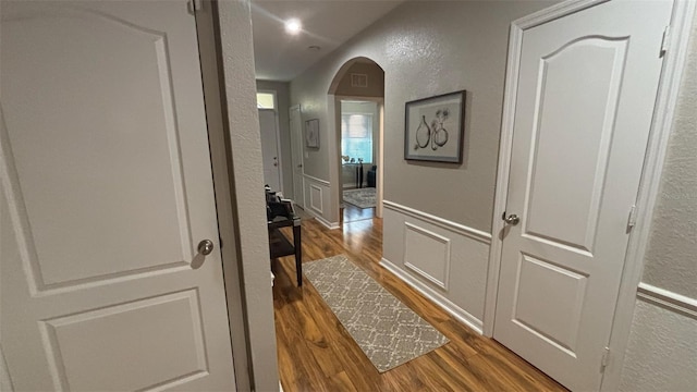 3828 Eloise Estates Ct, Winter Haven, FL 33881 - hall with a textured wall, wood finished floors, and arched walkways