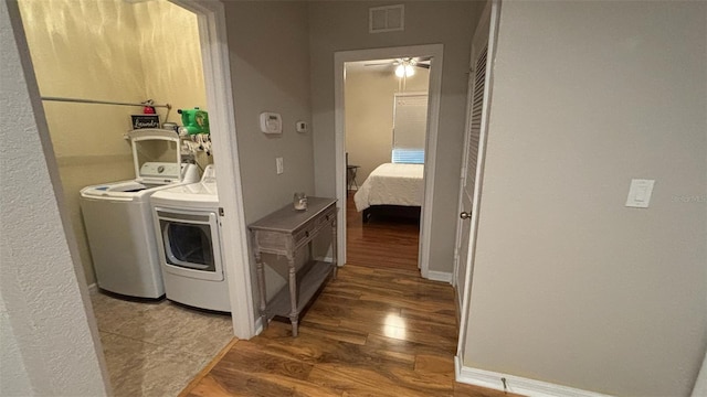 3828 Eloise Estates Ct, Winter Haven, FL 33881 - corridor with washing machine and clothes dryer, wood finished floors, and baseboards