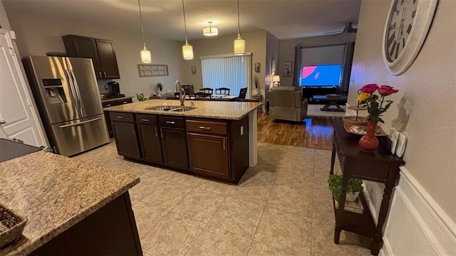 3828 Eloise Estates Ct, Winter Haven, FL 33881 - kitchen with stainless steel fridge with ice dispenser, a sink, light tile patterned floors, dark brown cabinetry, and pendant lighting