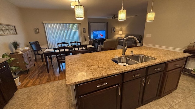 3828 Eloise Estates Ct, Winter Haven, FL 33881 - kitchen with a sink, open floor plan, dark brown cabinetry, and decorative light fixtures