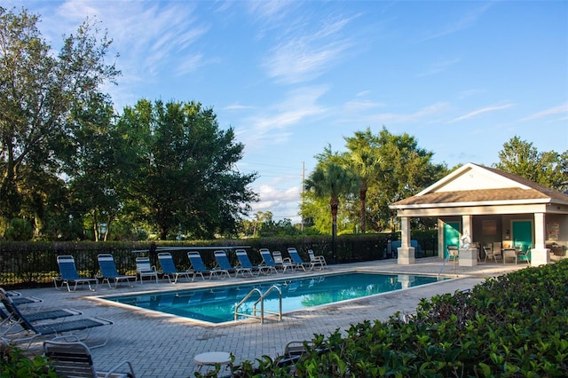 3828 Eloise Estates Ct, Winter Haven, FL 33881 - community pool with a patio, fence, and an outdoor structure