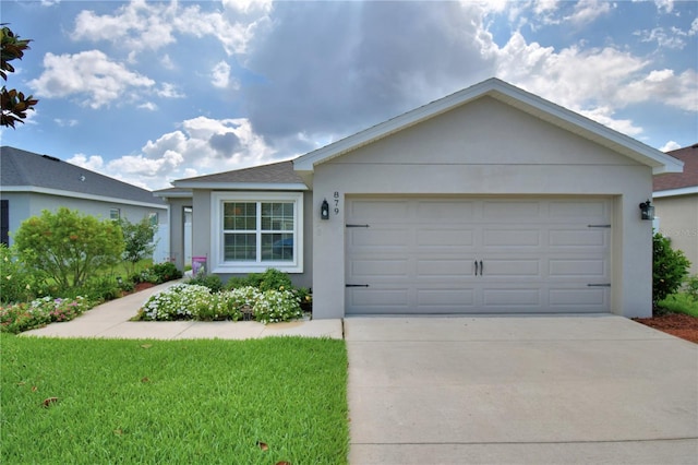 879 Orleans Dr, Eagle Lake, FL 33839 - single story home with stucco siding, driveway, a garage, and a front lawn