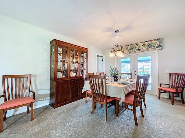 255 Lake Link Rd, Winter Haven, FL 33884 - dining space featuring french doors, light carpet, a chandelier, and baseboards