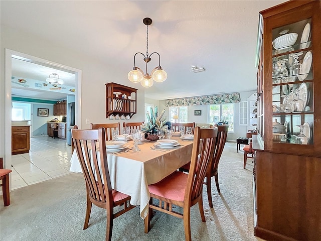 255 Lake Link Rd, Winter Haven, FL 33884 - dining room with light colored carpet and a chandelier