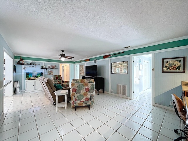 255 Lake Link Rd, Winter Haven, FL 33884 - living area with ceiling fan, light tile patterned floors, a textured ceiling, and baseboards
