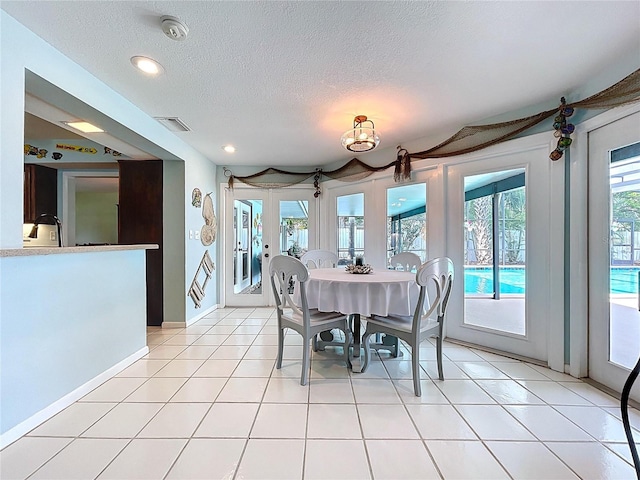 255 Lake Link Rd, Winter Haven, FL 33884 - dining room featuring a textured ceiling, light tile patterned floors, recessed lighting, and french doors