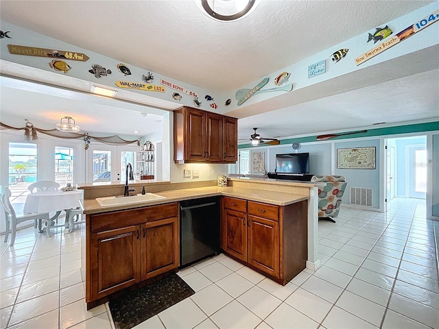 255 Lake Link Rd, Winter Haven, FL 33884 - kitchen with a sink, black dishwasher, a peninsula, open floor plan, and light countertops