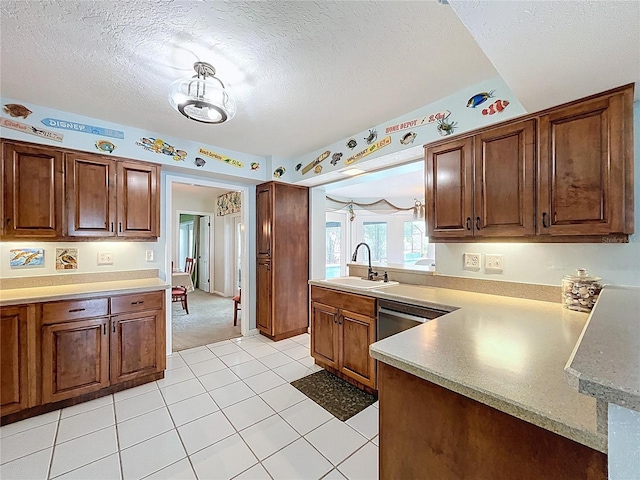 255 Lake Link Rd, Winter Haven, FL 33884 - kitchen featuring a sink, a peninsula, a textured ceiling, light countertops, and light tile patterned flooring