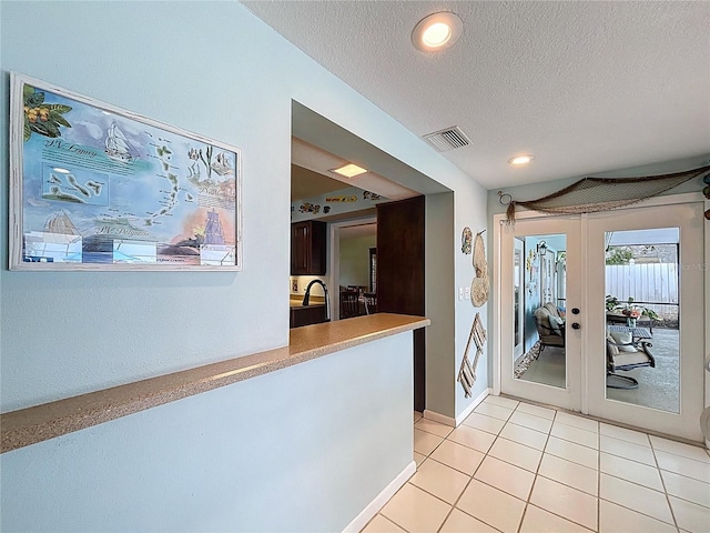 255 Lake Link Rd, Winter Haven, FL 33884 - hall with a textured ceiling, french doors, recessed lighting, and light tile patterned floors