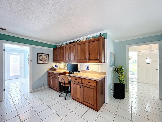 255 Lake Link Rd, Winter Haven, FL 33884 - office area with light tile patterned floors, crown molding, built in study area, a textured ceiling, and baseboards
