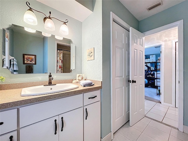 255 Lake Link Rd, Winter Haven, FL 33884 - full bathroom with a textured wall, vanity, and tile patterned flooring