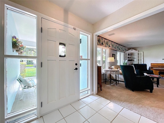 255 Lake Link Rd, Winter Haven, FL 33884 - foyer entrance featuring light colored carpet and light tile patterned flooring