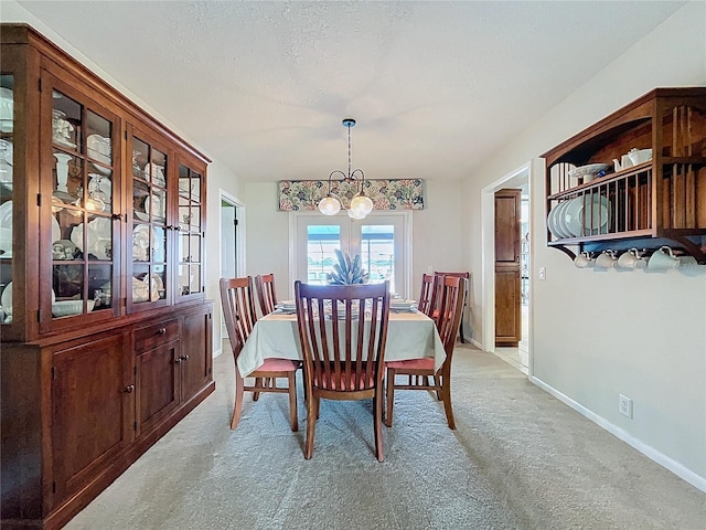 255 Lake Link Rd, Winter Haven, FL 33884 - dining space featuring light colored carpet, a chandelier, and baseboards