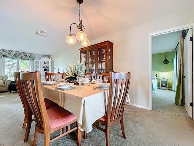 255 Lake Link Rd, Winter Haven, FL 33884 - dining space featuring light carpet, a chandelier, and baseboards