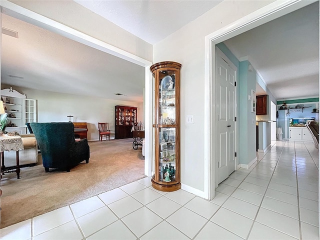255 Lake Link Rd, Winter Haven, FL 33884 - hallway featuring light carpet, light tile patterned flooring, and baseboards