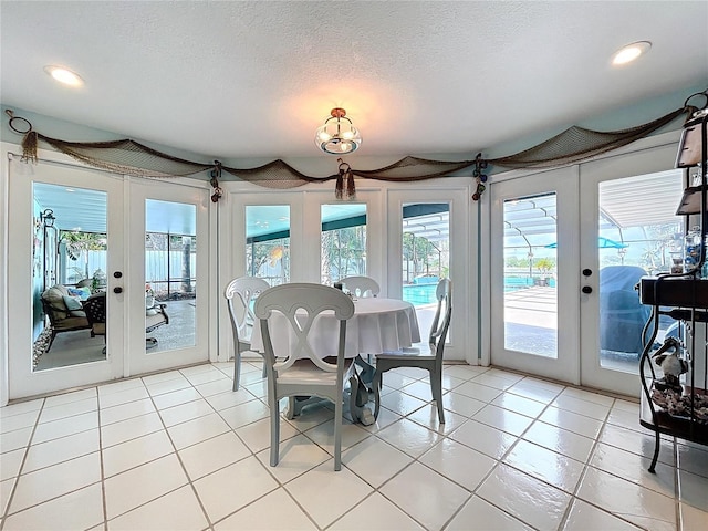 255 Lake Link Rd, Winter Haven, FL 33884 - dining space with french doors, plenty of natural light, a textured ceiling, light tile patterned floors, and recessed lighting