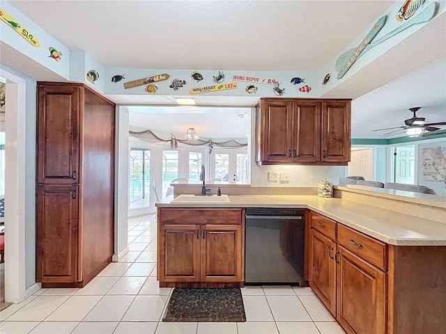 255 Lake Link Rd, Winter Haven, FL 33884 - kitchen with black dishwasher, a sink, a peninsula, light countertops, and light tile patterned floors