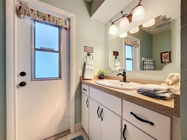 255 Lake Link Rd, Winter Haven, FL 33884 - bathroom with vanity, plenty of natural light, baseboards, and tile patterned flooring