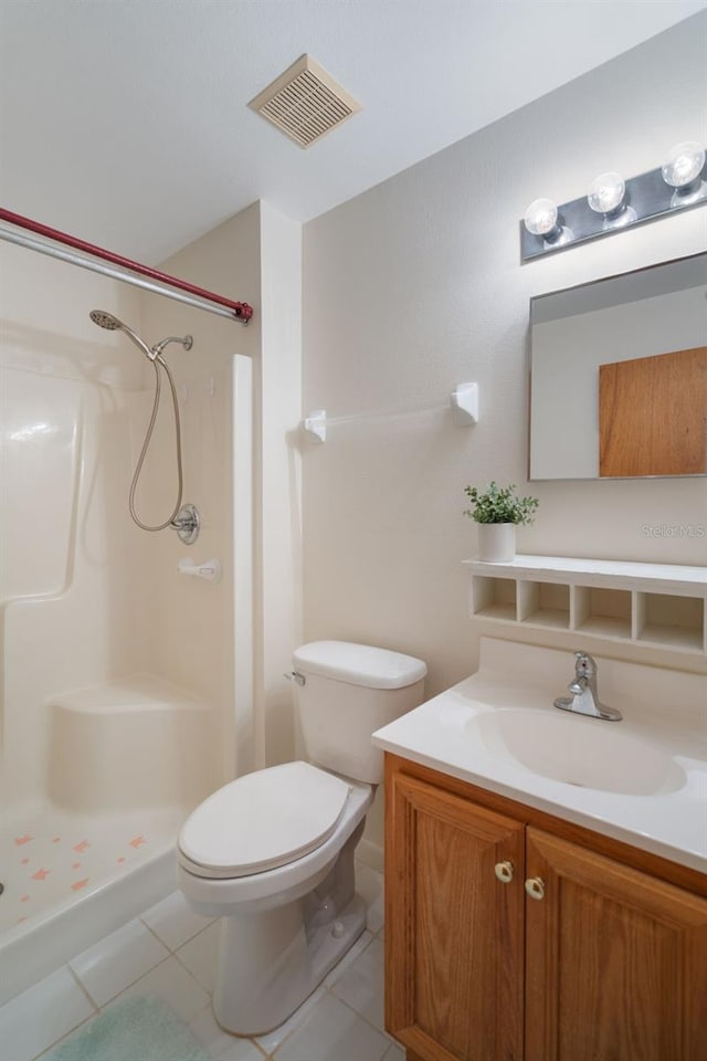 1408 Thousand Roses Dr S, Lake Wales, FL 33853 - bathroom featuring tile patterned flooring, toilet, a stall shower, and vanity
