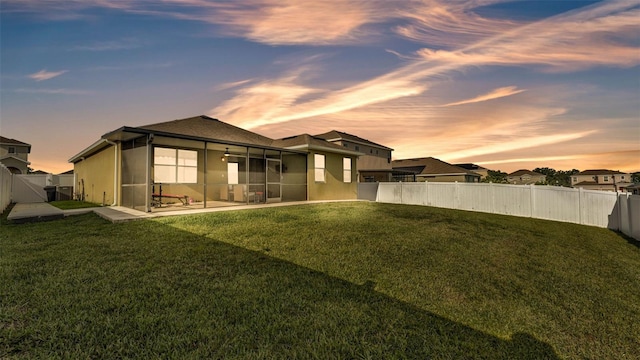 428 Aragosa Dr, Davenport, FL 33837 - back of property at dusk with a sunroom and a patio area