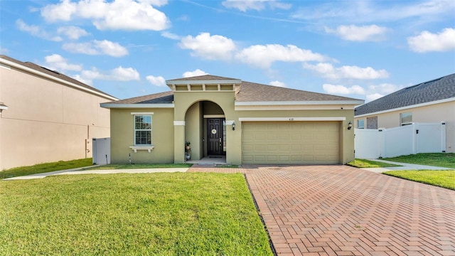 428 Aragosa Dr, Davenport, FL 33837 - mediterranean / spanish house with stucco siding, decorative driveway, an attached garage, and roof with shingles