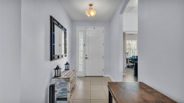 428 Aragosa Dr, Davenport, FL 33837 - entryway with light tile patterned flooring, arched walkways, and baseboards