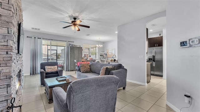 428 Aragosa Dr, Davenport, FL 33837 - living room featuring ceiling fan, light tile patterned floors, arched walkways, and baseboards