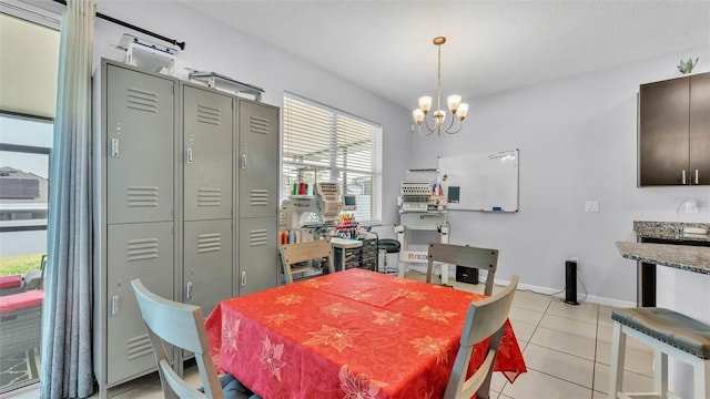 428 Aragosa Dr, Davenport, FL 33837 - dining area with a chandelier, light tile patterned floors, and baseboards