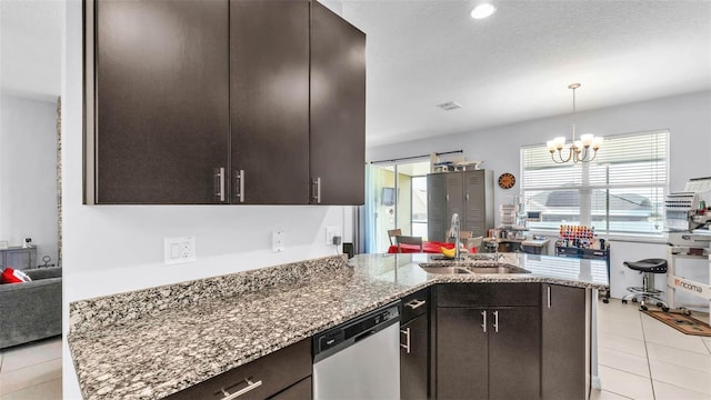 428 Aragosa Dr, Davenport, FL 33837 - kitchen with dishwasher, a sink, a peninsula, a chandelier, and stone countertops