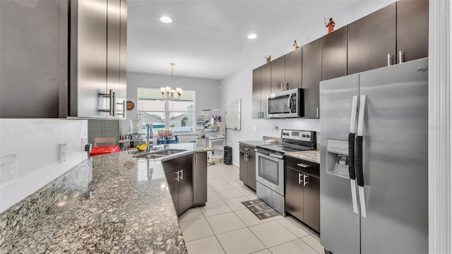 428 Aragosa Dr, Davenport, FL 33837 - kitchen with stainless steel appliances, a sink, a chandelier, light tile patterned floors, and recessed lighting