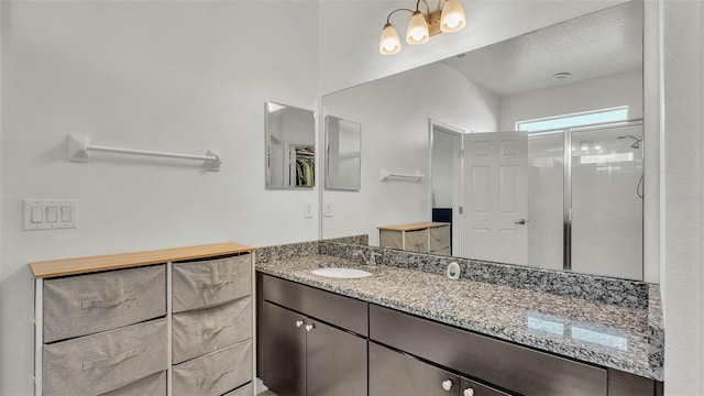 428 Aragosa Dr, Davenport, FL 33837 - bathroom with a stall shower, vanity, and a textured ceiling