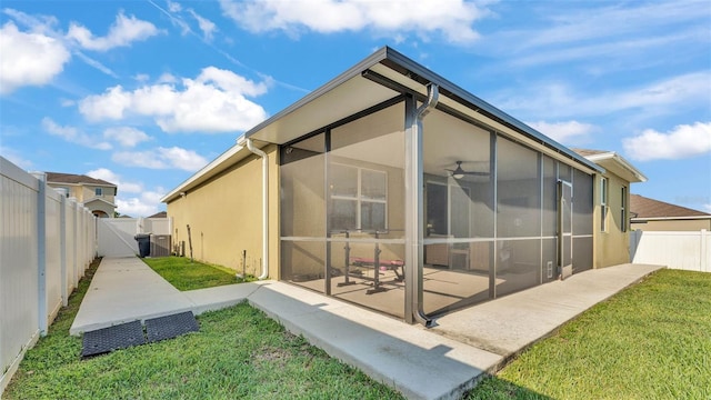 428 Aragosa Dr, Davenport, FL 33837 - rear view of house with a patio area, a gate, stucco siding, a sunroom, and a ceiling fan