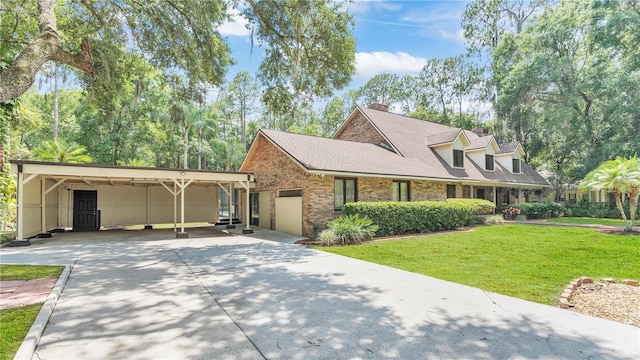418 N Rd, Lakeland, FL 33809 - view of front of home featuring driveway, a front lawn, brick siding, and a garage