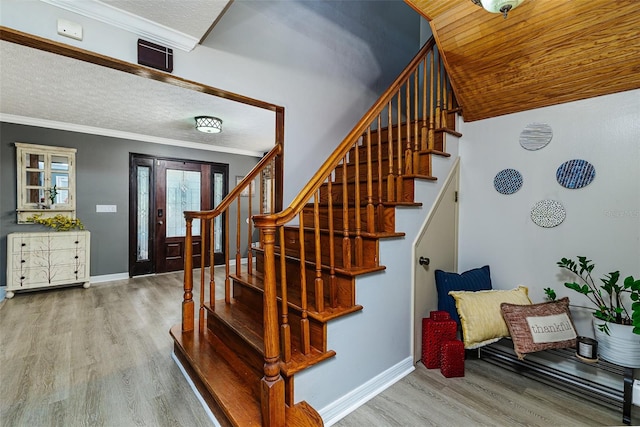 418 N Rd, Lakeland, FL 33809 - stairs with wood finished floors, crown molding, and baseboards