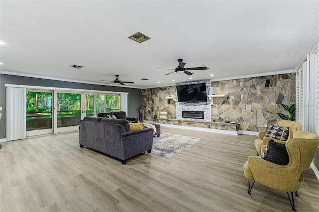 418 N Rd, Lakeland, FL 33809 - living room featuring ornamental molding, ceiling fan, recessed lighting, a stone fireplace, and light wood-type flooring