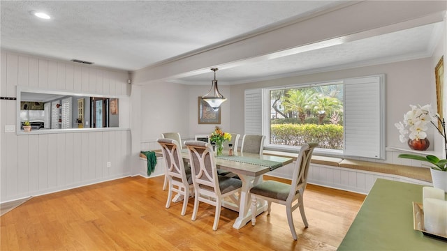 418 N Rd, Lakeland, FL 33809 - dining room featuring a textured ceiling, wood finished floors, crown molding, a decorative wall, and recessed lighting
