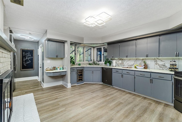 418 N Rd, Lakeland, FL 33809 - kitchen with dishwasher, gray cabinets, wine cooler, light wood finished floors, and a textured ceiling