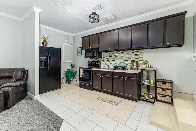 418 N Rd, Lakeland, FL 33809 - kitchen with black appliances, light countertops, backsplash, light tile patterned floors, and open floor plan